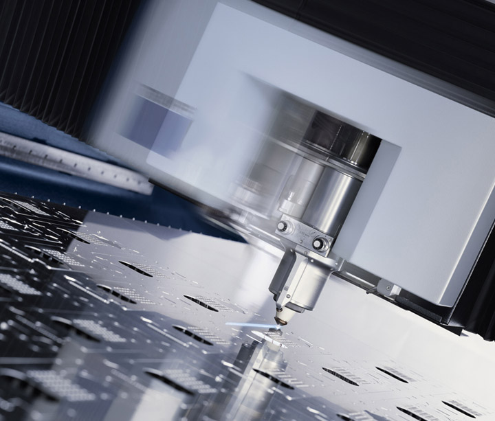 Laser cutting head moving across a metal sheet with cut-out profiles